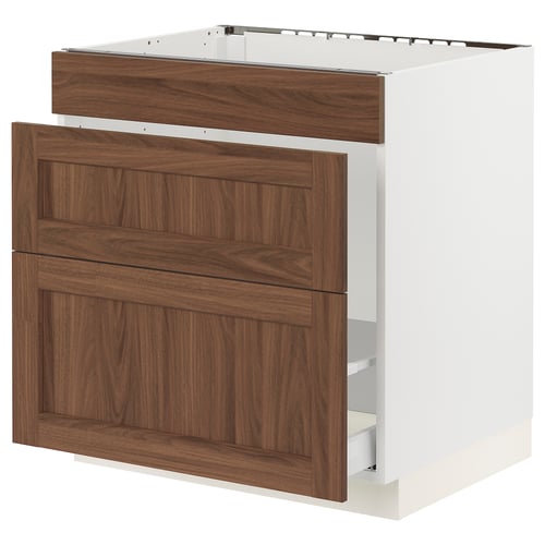 A white SEKTION kitchen cabinet with walnut drawers and doors. It two drawers and a large door, combining modern and classic designs.