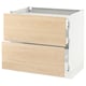 Light-colored wooden drawers on white cabinet base.