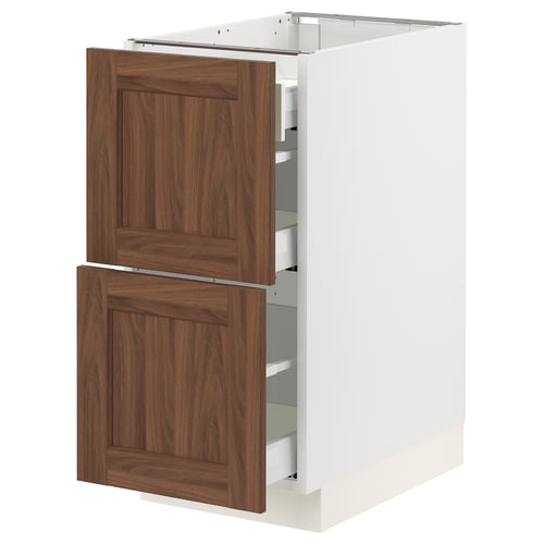 A white ikea SEKTION kitchen cabinet with walnut-colored wood doors and multiple drawers.