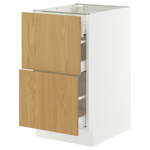 An IKEA SEKTION kitchen cabinet with oak veneer sinarp drawers. Its white with wooden handles, rectangular, and has two open drawers.