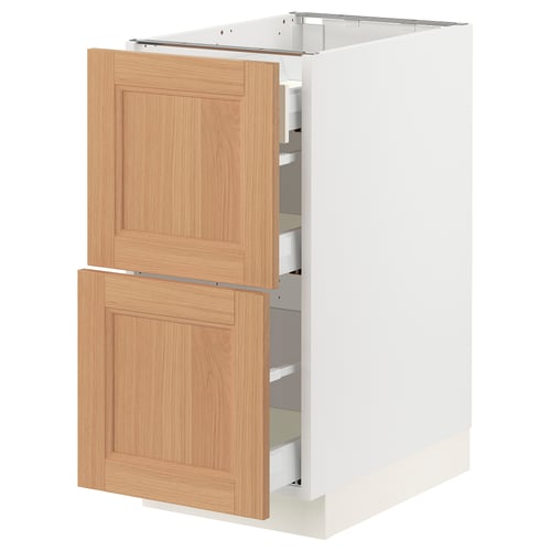 An ikea SEKTION kitchen cabinet with oak drawers. The cabinet is white with wooden drawers featuring a natural, warm look.