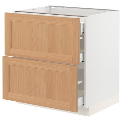 An ikea SEKTION kitchen cabinet with white base and oak drawers, featuring a modern, natural design.