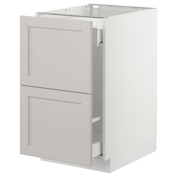 Displays a white SEKTION kitchen cabinet with a classic design, featuring two drawers and a door, made from birch and particleboard.