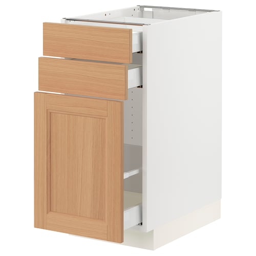 White SEKTION kitchen cabinet with light oak drawers and door, three drawers and one door.