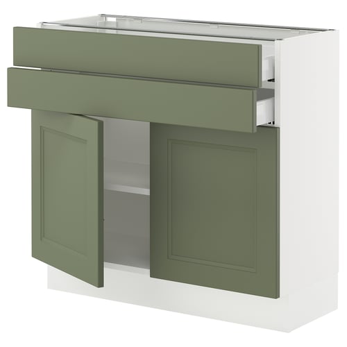 Green kitchen cabinet with open door and drawer, modern design, stainless steel handle, adjustable shelf.