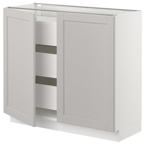 A white SEKTION kitchen cabinet with one open door, featuring three shelves and a traditional design.