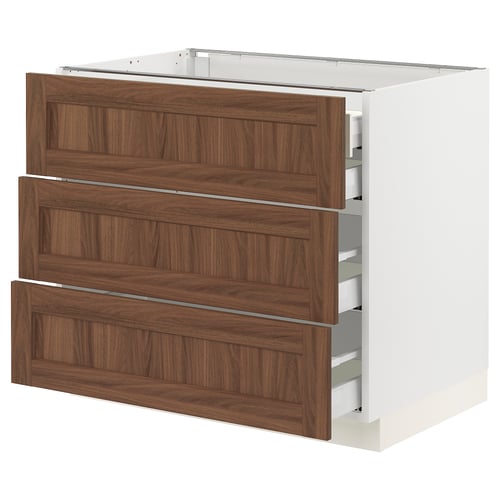 Modern kitchen cabinet, white base with three dark wooden drawers.