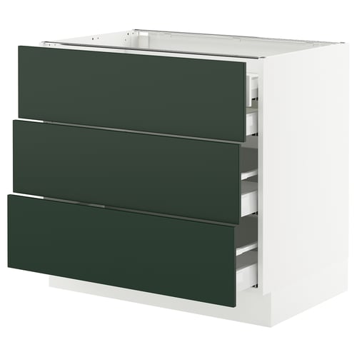 A SEKTION kitchen cabinet with three dark green drawers and a white base.