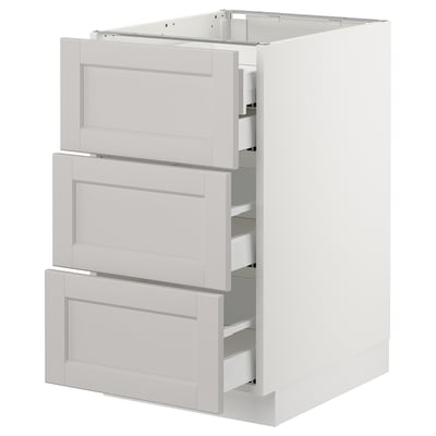 A white SEKTION kitchen base cabinet with three lerhyttan light grey drawers featuring bevelled edges.