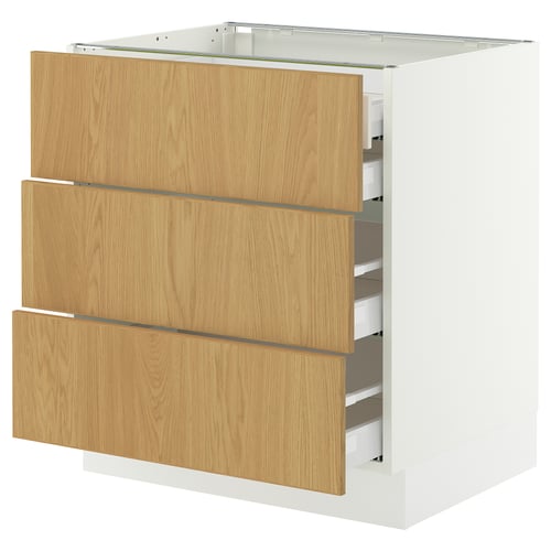 An IKEA SEKTION kitchen cabinet in white with oak veneer drawers. It has three drawers, each with modern, minimalistic handles.