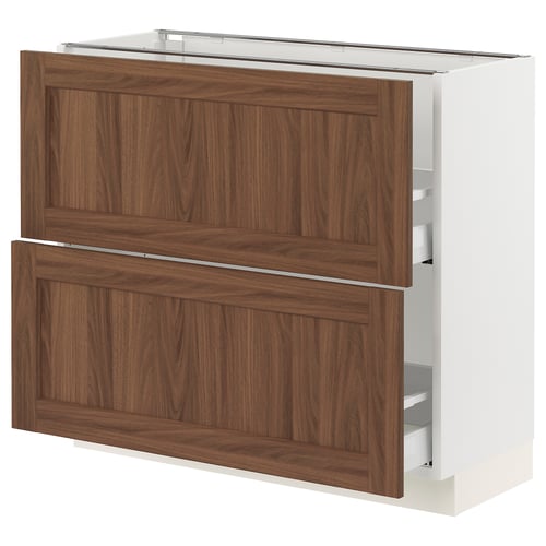 An ikea SEKTION kitchen cabinet with walnut-colored wooden panels and a white base. It has two drawers and a door.