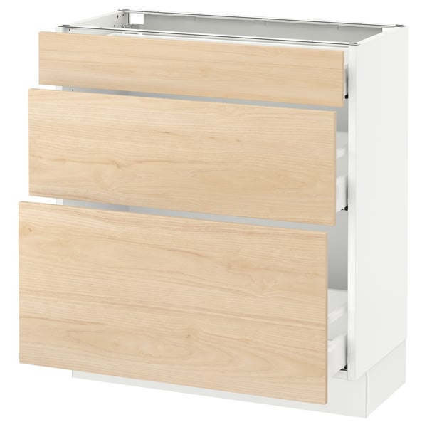 An ikea SEKTION kitchen cabinet with light-colored wooden drawers and a white frame.