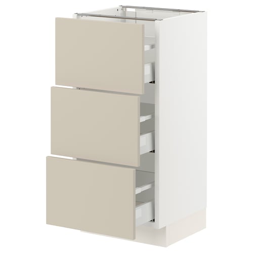 White SEKTION kitchen cabinet with beige drawers.