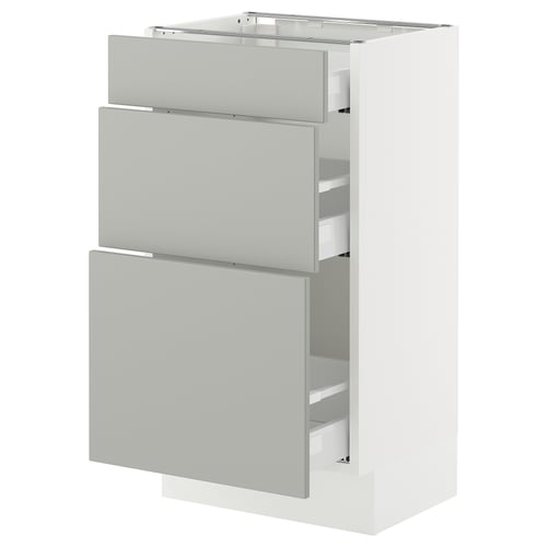 A white SEKTION kitchen cabinet with three grey drawers, modern design.