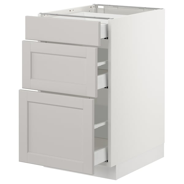 White SEKTION kitchen cabinet with three grey drawers, classic design.