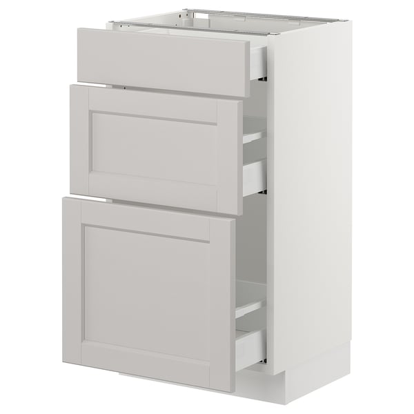 White SEKTION kitchen cabinet with three pull-out drawers, simple modern design.