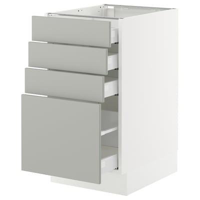 A white modern kitchen cabinet with light grey drawer fronts, featuring four drawers and a door.