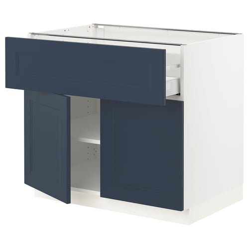 Blue kitchen cabinet in modern design with white frame, open door revealing shelf.