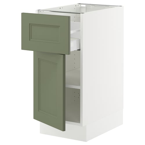 This image shows a white SEKTION kitchen cabinet with a green-gray door and drawer. The door is open, revealing adjustable shelves inside.