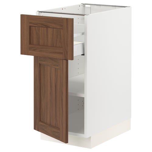 White kitchen cabinet with walnut door, partially open.