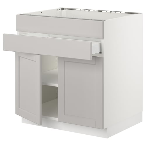White kitchen cabinet, with one open door and adjustable shelves.