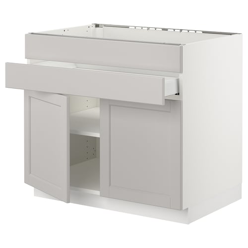 White SEKTION kitchen cabinet with bevelled grey doors and adjustable shelves.
