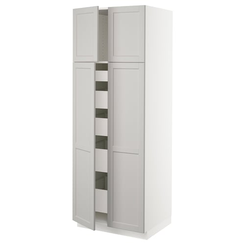 A white SEKTION kitchen cabinet with four doors and multiple shelves. It has a sleek, modern design with a sturdy build and smooth-running drawers.