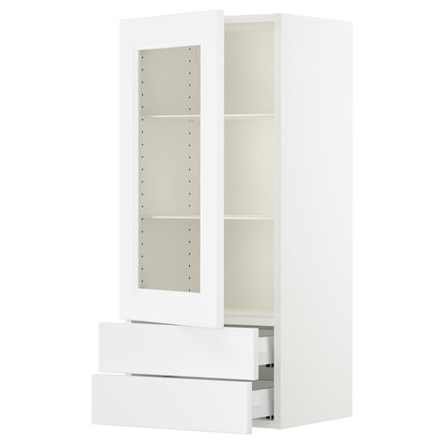 Displays a white SEKTION kitchen cabinet with adjustable shelves. It a glass door and multiple drawers.