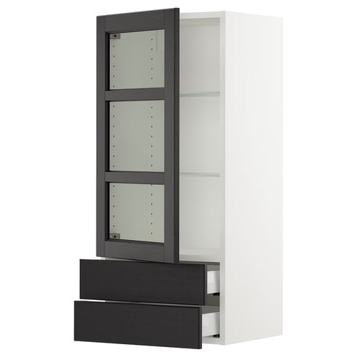 A SEKTION wall cabinet in white with dark grey stained wood and glass doors. It has an adjustable shelf and two drawers below the cabinet.