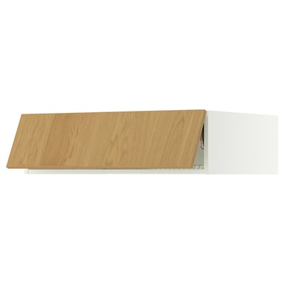A modern wooden and white kitchen cabinet. Its rectangular with a slanted door. The door is light oak and the frame is white.