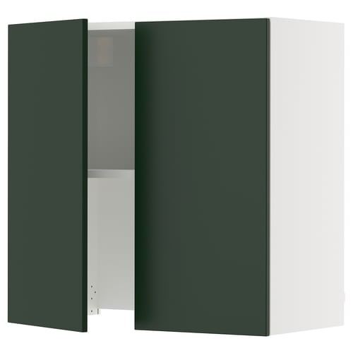 Dark green wall-mounted cabinet with one open door, showcasing interior shelves. Part of the SEKTION kitchen system.