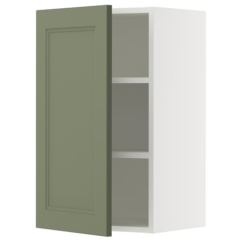 Green SEKTION cabinet door by IKEA, simple design with flat panel, in minimalist wall cabinet with glass shelves.