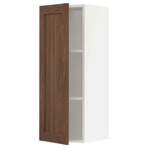 White kitchen cabinet with walnut door open.