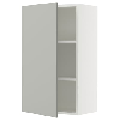 A grey SEKTION kitchen cabinet with one open door, revealing shelves inside.