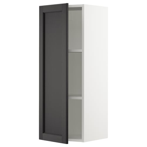 A white wall-mounted kitchen cabinet with a tall, dark wood-finished door partially open, revealing glass shelves.