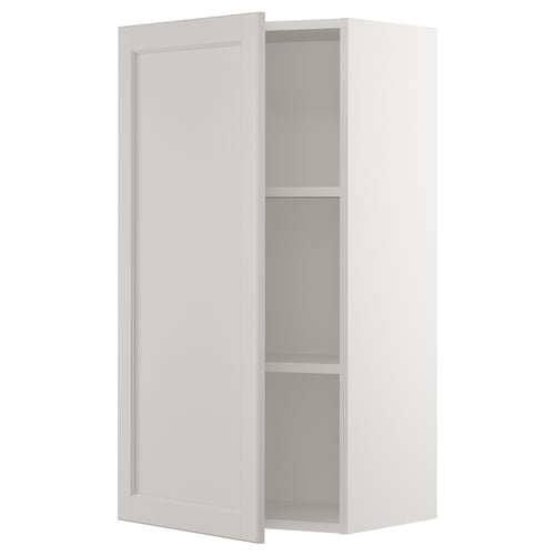 A white SEKTION kitchen cabinet with a door and adjustable shelves.