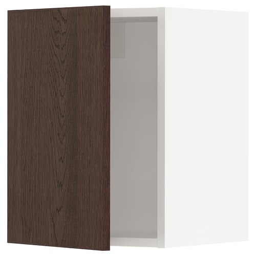 An open dark brown wooden kitchen cabinet door from the SEKTION system by IKEA.