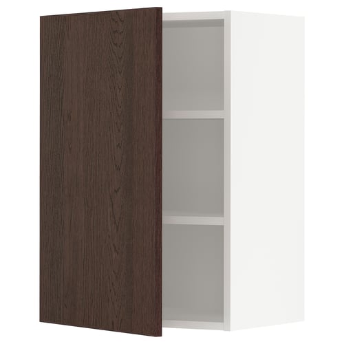 Dark brown wooden cabinet door open, revealing white shelves inside.