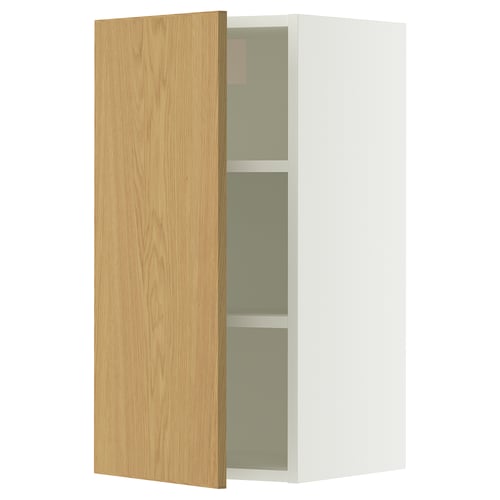 A white SEKTION wall cabinet with an oak veneer door, featuring an adjustable shelf inside.
