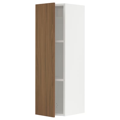 A modern white kitchen cabinet with a single brown wooden door partially open, revealing adjustable shelves.