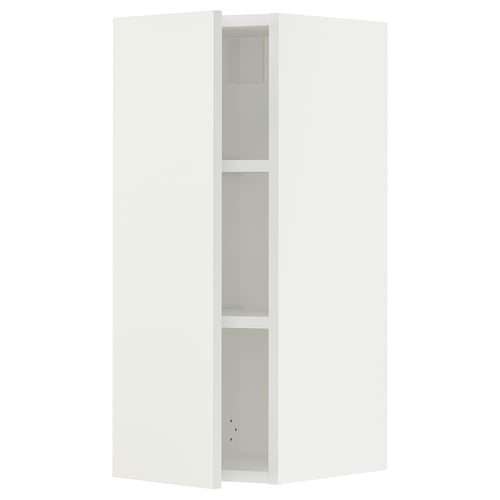A white SEKTION wall cabinet from ikea with shelves and a door.