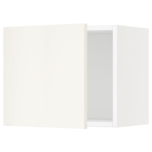 A white SEKTION kitchen cabinet with one open door, featuring clean lines and a sleek design.