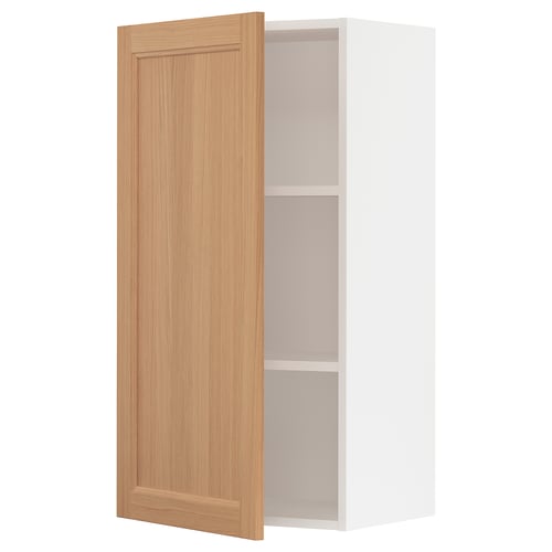 An open white kitchen cabinet with a wooden door.