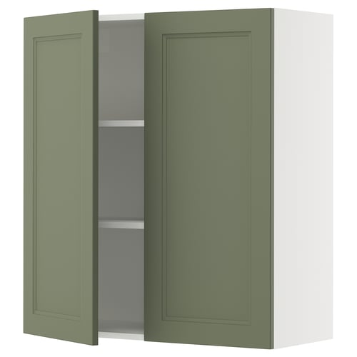 An olive green SEKTION wall cabinet with one open door, revealing inner shelves. The cabinet has a modern, rectangular shape and a smooth surface.