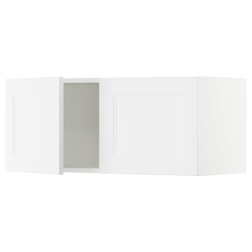 White ikea SEKTION kitchen cabinets with a door open, revealing a light green interior.