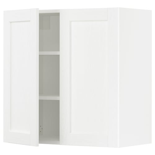 White kitchen cabinet with one open door showing shelves.