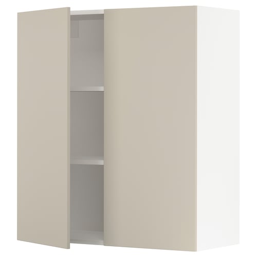 A beige SEKTION kitchen cabinet with one door open, revealing adjustable shelves and a soft-close hinge.