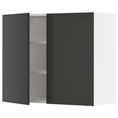 Modern black kitchen cabinet with silver shelves and one open door.