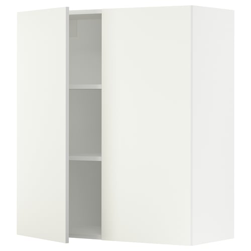 A white SEKTION kitchen cabinet with two doors and adjustable shelves.