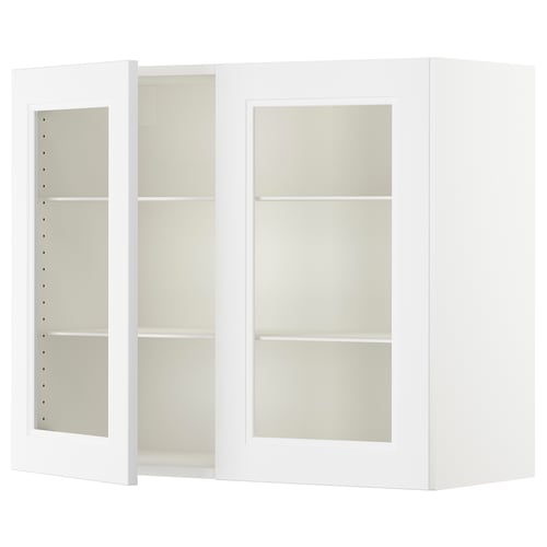 A white SEKTION kitchen cabinet with adjustable glass shelves and glass doors.